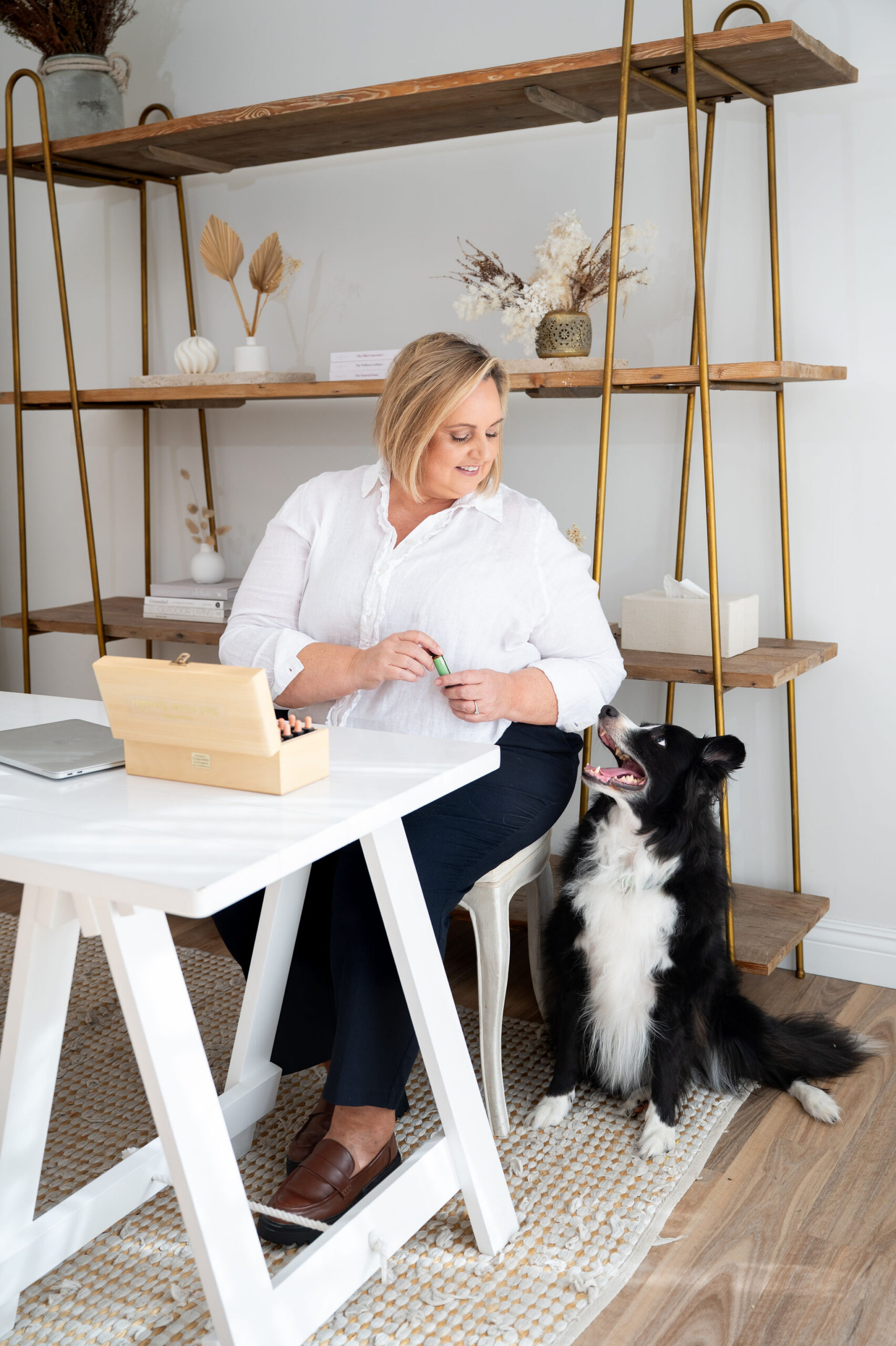 Claire working with her remedies kit beside her border collie